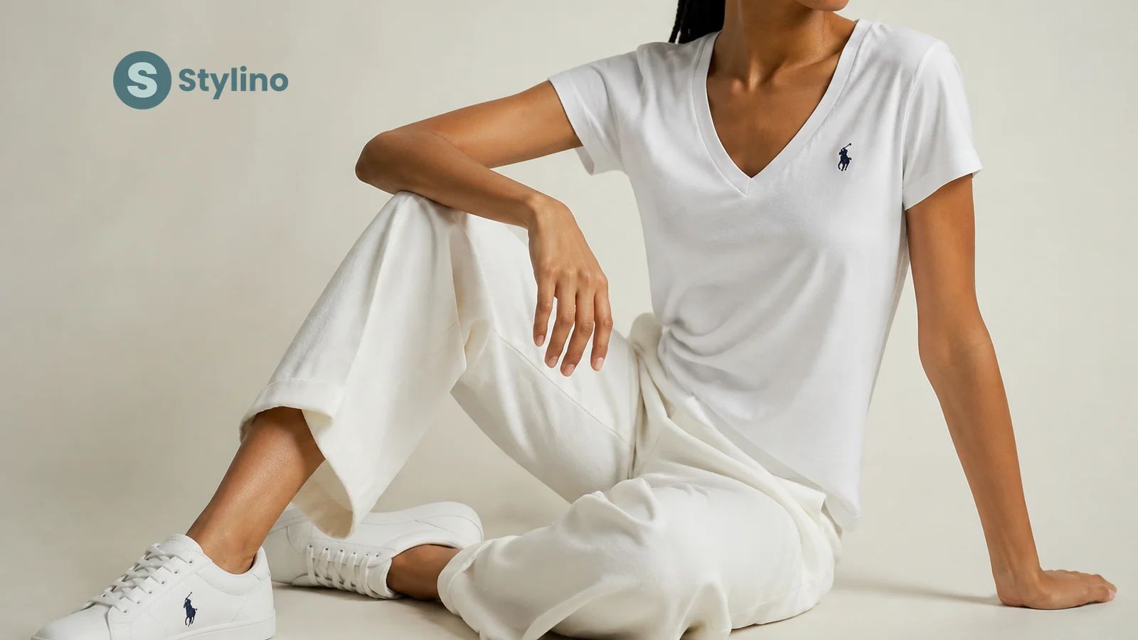 Polo Ralph Lauren women's style guide — editorial composition of white polo shirt, leather shoulder bag, white sneakers, and reversible belt on a teal background